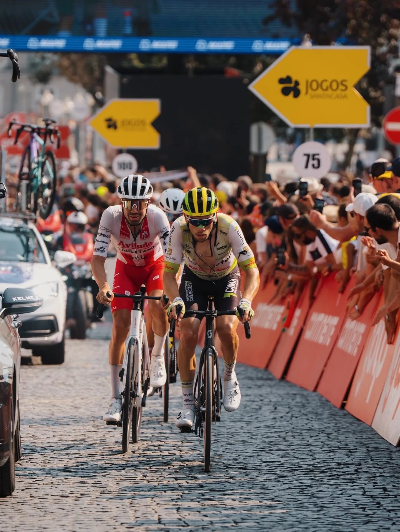 Daniel Viegas sprinting on cobblestones alongside another rider